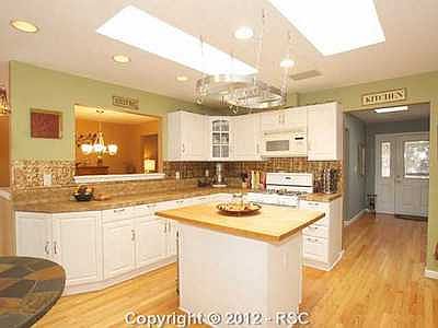 Large light  bright kitchen wHardwood floors  Island