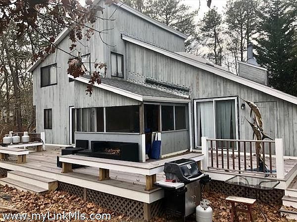 Back exterior with large deck and screened porch