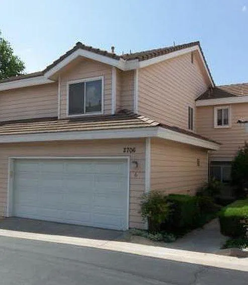 Two car garage directly attached to the town house and house entry (right)