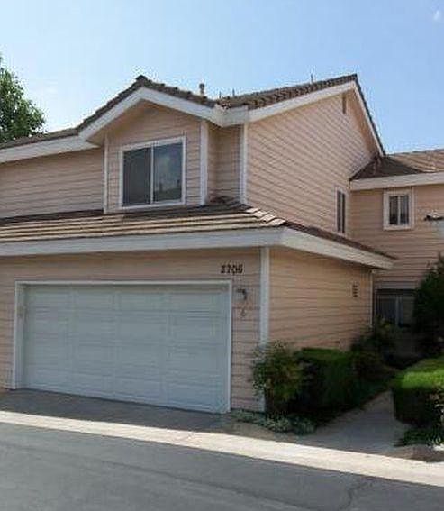 Two car garage directly attached to the town house and house entry (right)
