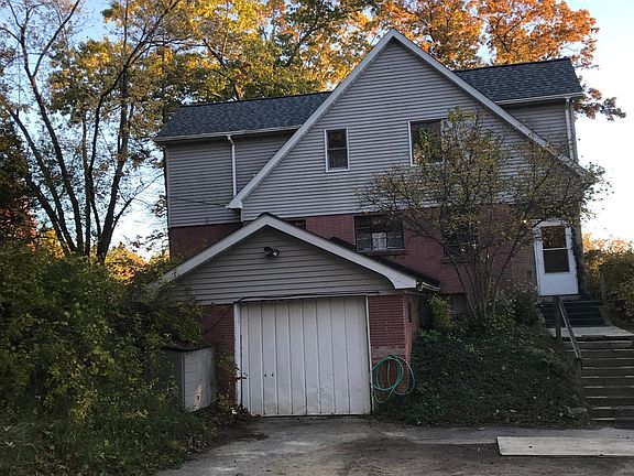 One car garage with paved outdoor parking for two additional cars