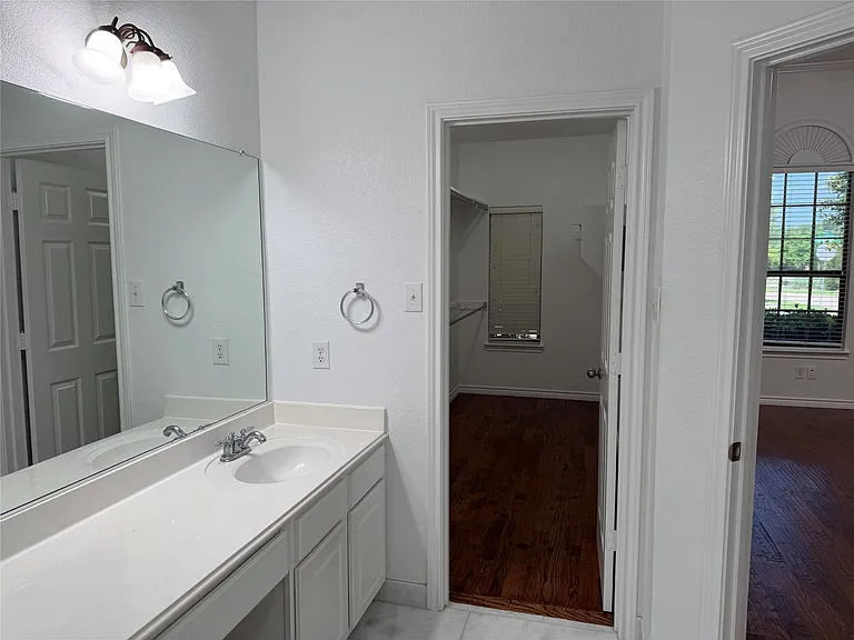Dual vanities and large walk-in shower.