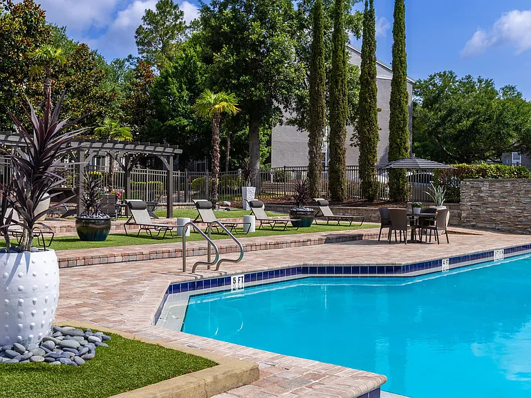 Our expansive pool deck features lounge chairs, shaded seating, and lush landscapingoffering the ideal backdrop for your daily escape.