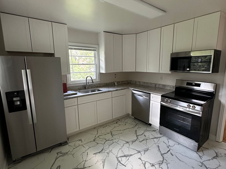Totally new appliances, marble floors, granite countertops and wood cabinets in this spacious kitchen