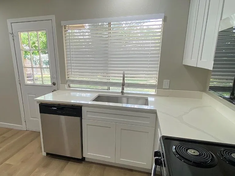 Kitchen with new counters, farm sink, light fixtures and appliances