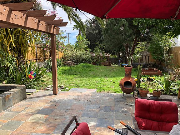 slate patio and large fenced backyard