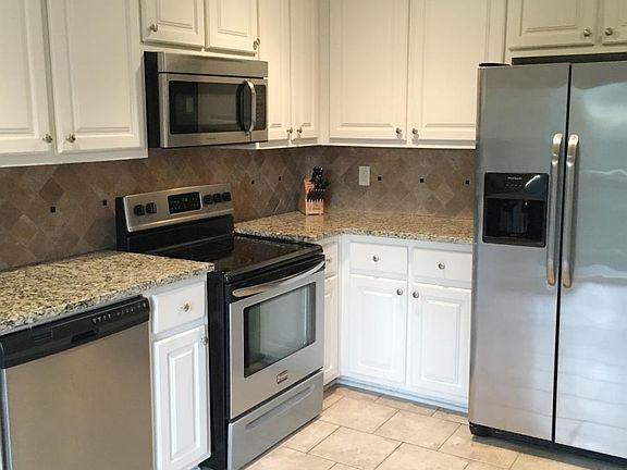 Beautifully updated kitchen with granite countertops and sta