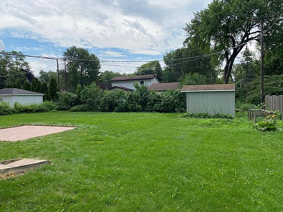 Large un-fenced yard with shed.