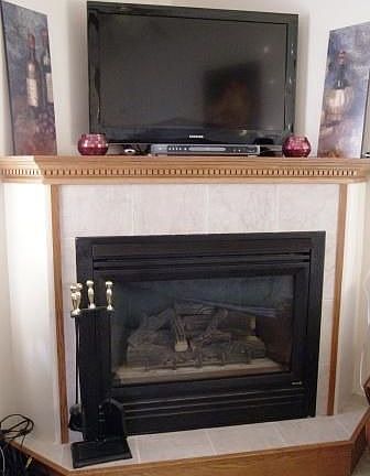 Fireplace - Gas with remote temperature control and oak mantle corner fireplace