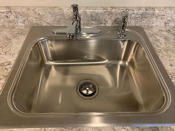 Farm-house style stainless sink.