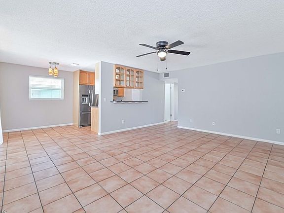Large open living area with huge sliding door on left that folds in to expand living space out to open porch.