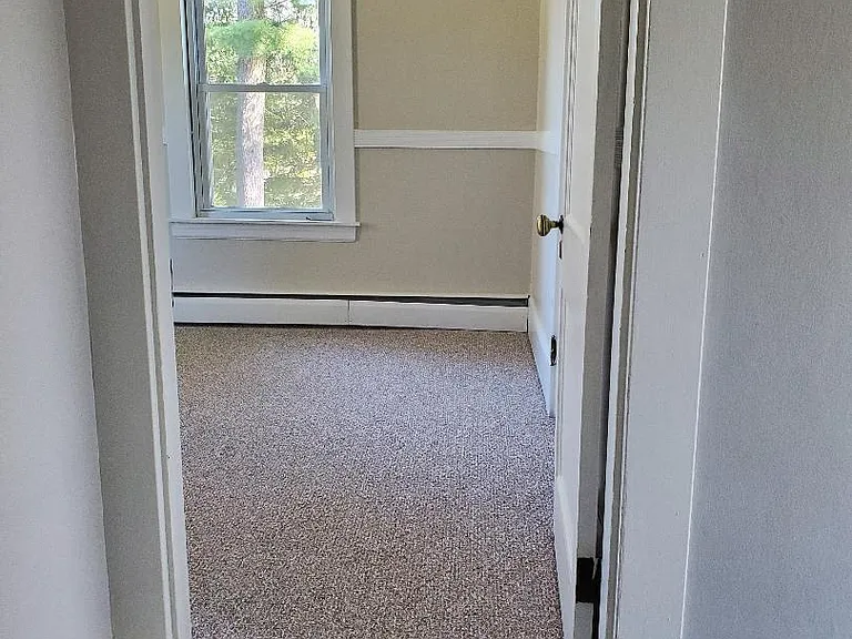 Hallway from bedroom 2, bathroom on left and bedroom 3 straight ahead.