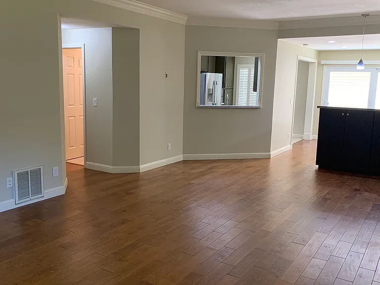 Half a bath next to living room, and stairs to downstairs.