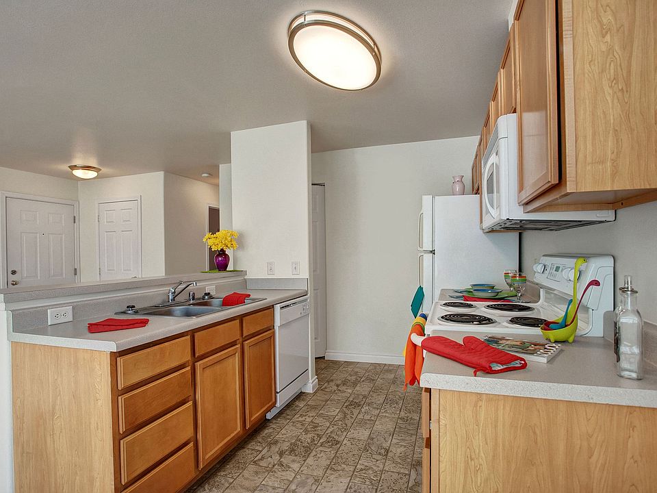 A kitchen with plenty of counter space, a breakfast bar, and lots of cabinet storage space