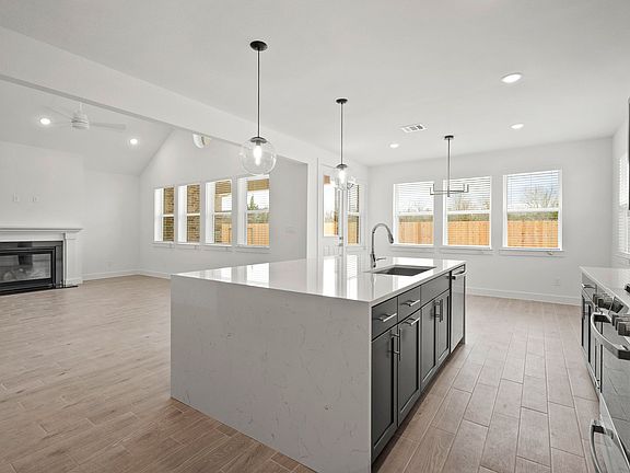 Kitchen with sleek pendant lighting