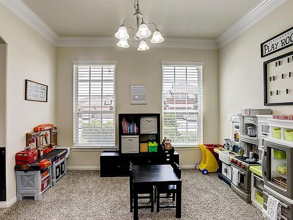 To the left of the front door is the Formal Dining Room which is also a great kids play area that connect directly to the kitchen.