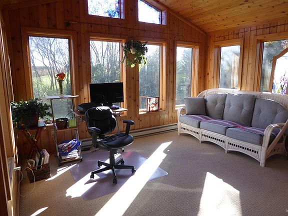 SUN FILLED SUN ROOM Makes the most of it's peaceful surroundings! (Vaulted with ceiling fan)