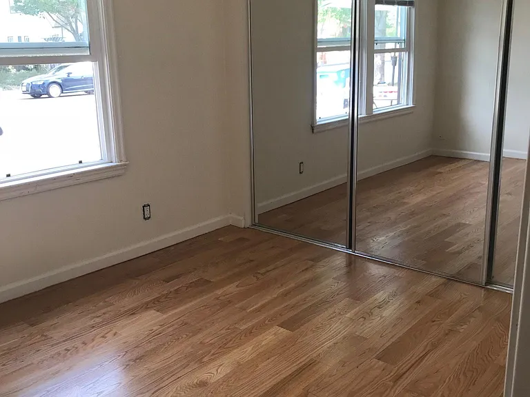 Bedroom has large closet with 3 full mirrors