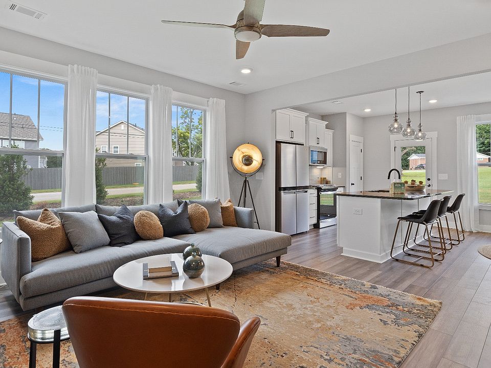Spacious hardwood flooring family room with ceiling fan at Barton Hollow by DRB Homes in Fountain In