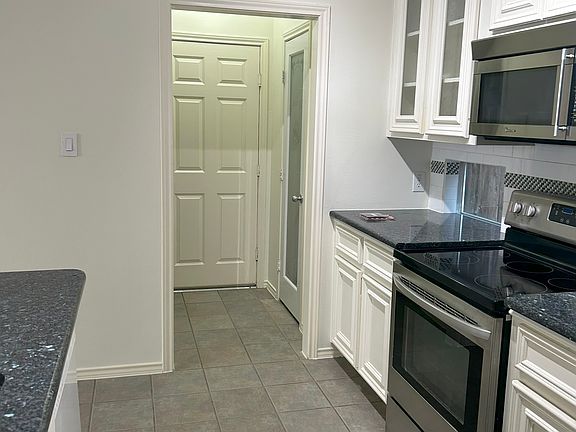 kitchen leading to half bath, pantry and garage