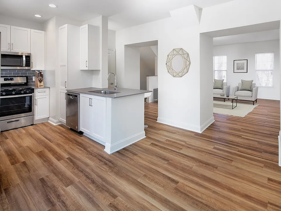 Kitchen, living, and dining areas with hard surface flooring