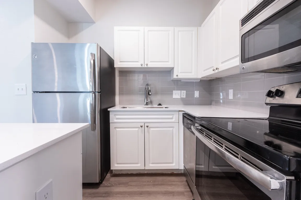 Renovated kitchens include stainless steel appliances and quartz countertops