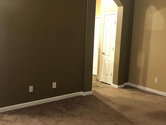 Living room area with kitchen entrance