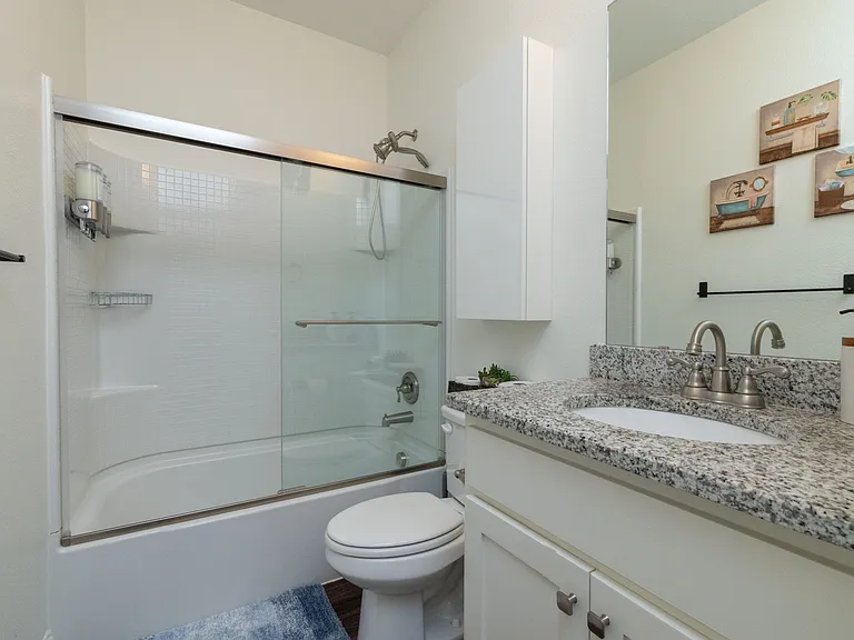 Bathroom 2 includes a tub/shower combo and a granite countertop sink_stylish and functional for a refreshing stay.