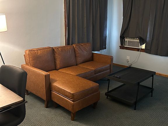 Living room #1 This is the living room in the house you will use! It has a couch, desk with chair and TV with Roku! (The window air conditioner in the room is gone and the house has central air now!!)