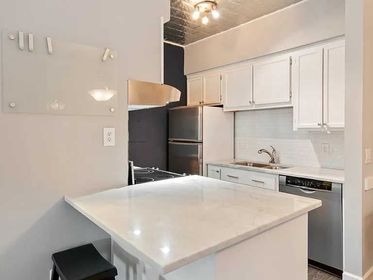 Beautifully updated kitchen with quartz countertops, stainless steel appliances, and a clean, timeless design.