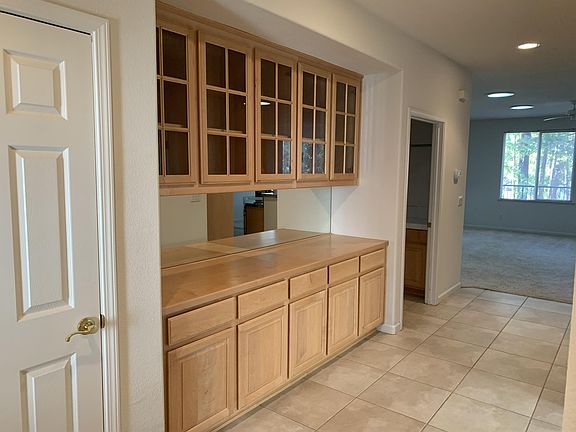 Entry area with storage closet and MORE storage cabinets.