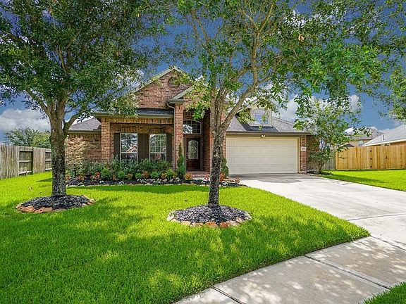 Beautiful Curb appeal with double driveway, mature trees and lush landscape.