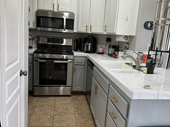 Kitchen with stainless steel appliances and pantry