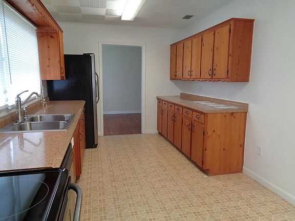 Spacious country kitchen features extra space for table or computer space.
