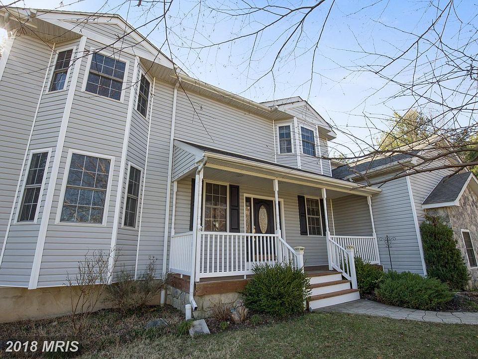 Charming Colonial style features brick and stone.