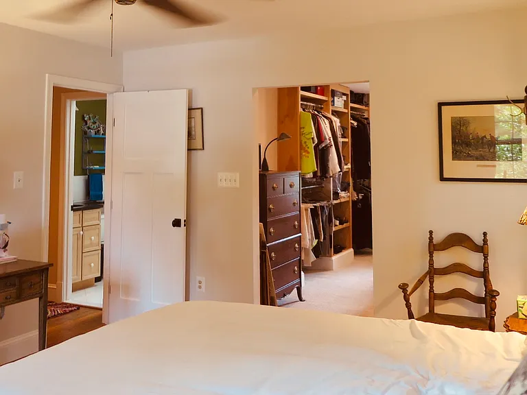 Primary bedroom facing hallway and closet entrance.