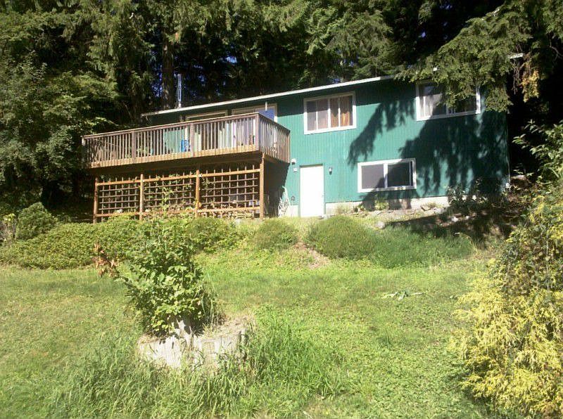 Main house has partially finished basement area and sun-soaked deck. This portion of the yard gets full afternoon sun and is a perfect area for a garden.