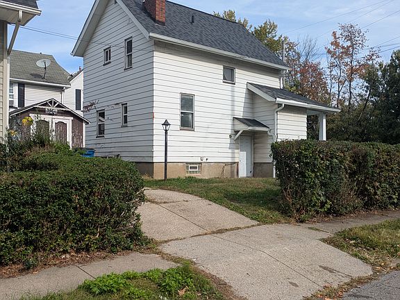 Side door and driveway. There is a shed that is able to be used for storage.