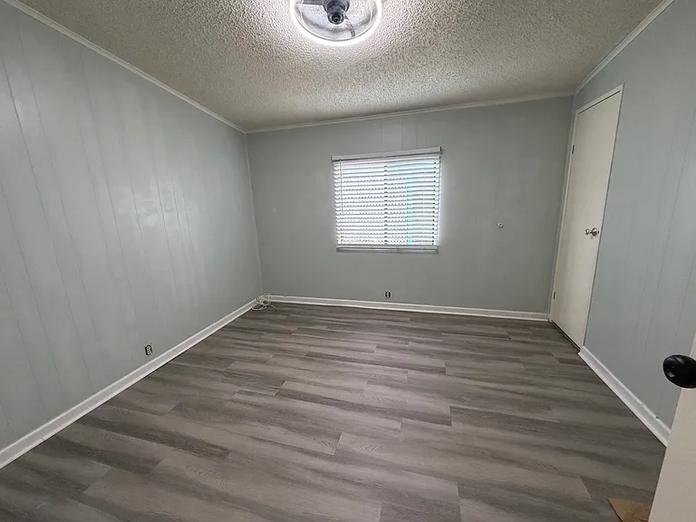Guest bedroom with walk in closet and ceiling fan with remote