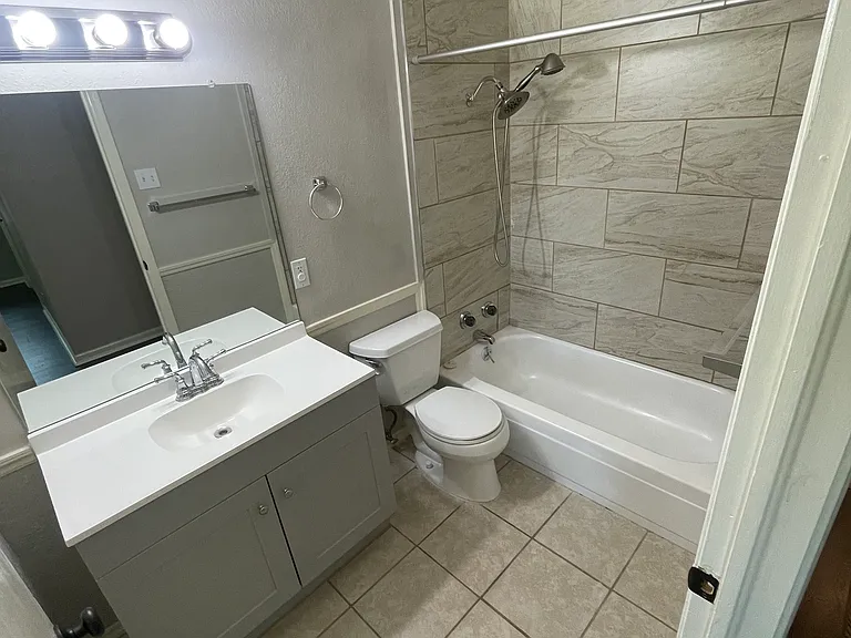 Newly tiled shower surround and new vanity.