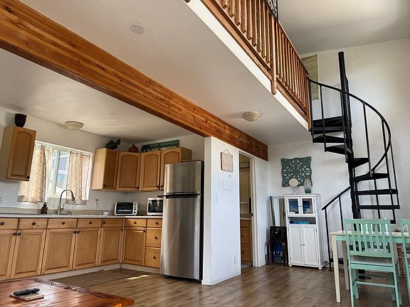 living area with view of loft and bathroom