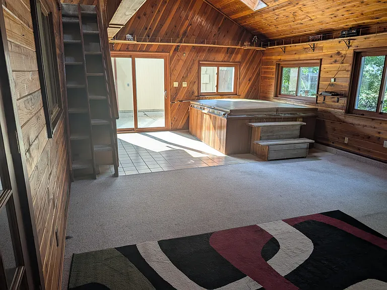 Upstairs hot tub room with fire place, electric train set and loft