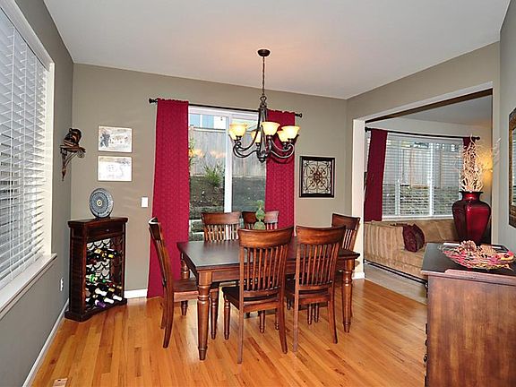 Lots of natural lighting streams through the windows & sliding glass doors of this comfortable dinin