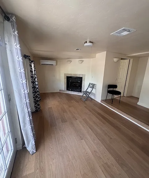 2nd living room with new flooring and 2nd full bathroom off the kitchen