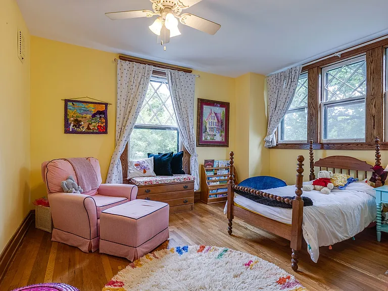 Bedroom 2 with large windows and cozy sitting area.