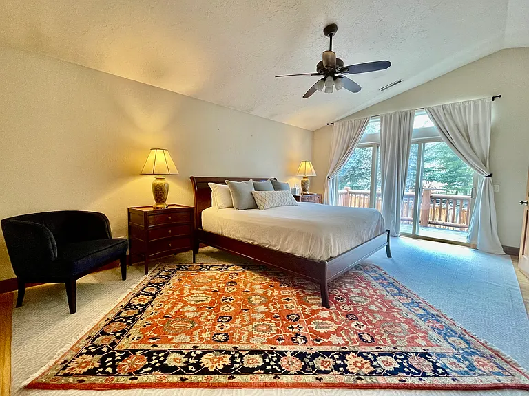 Extra large primary suite with walk out sliding door to private upper deck with views of Northshore lake and ski resort views