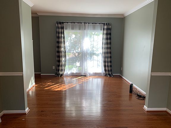 Formal living room, open to dining room. Windows face front of house