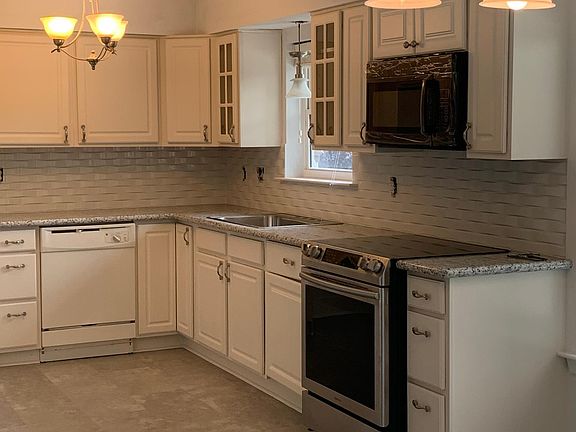 Renovated kitchen new appliances, granite counters and subway tile backsplash