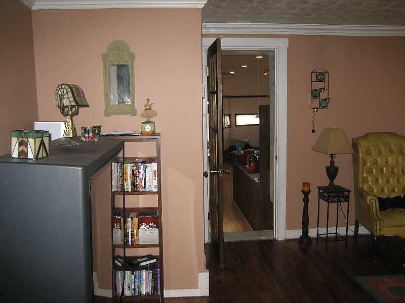 Bedroom area in the rear of the house with another den-sized rooom behind it. 