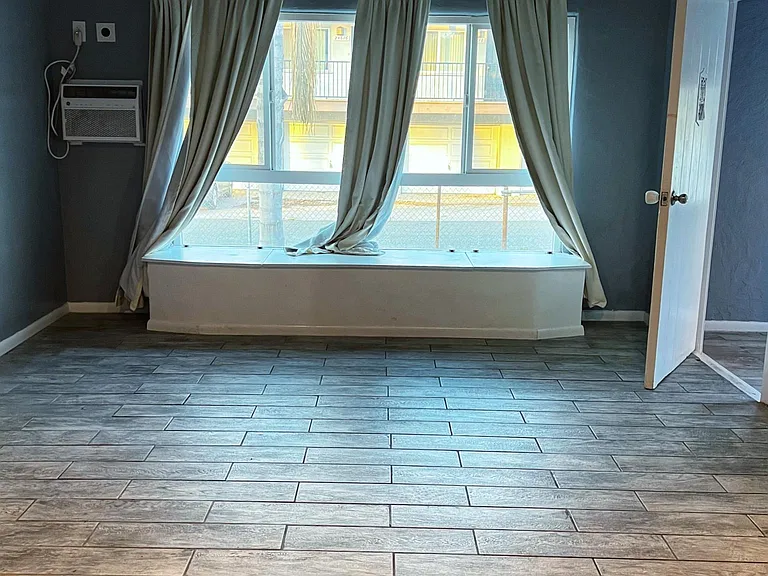 Living room, large window with sitting area with three storage benches